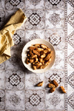 Brown and white tiles with a vintage pattern. Backdrop for food photography. Displyes with cookies and a yellow napkin. Used for product and food photography 