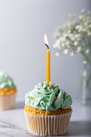 Cupcake displayed with backdrop white old wall on the background. Cupcake with candle and flowers on the background. Backdrop for cake and food photography