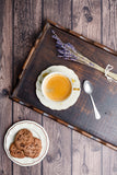 Backdrop for food photography wooden table flat lay setting with on top a wooden tray with cup of coffee and cookies. 