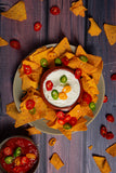 Foodphotograohy of plate of nachos styled on matte backdrop