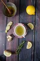 Vinyl backdrop of wood print with on top cup of tea, ginger, lemon and rosemary. Wipeable backdrop