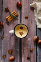 Christmas setting for foodphotography. Vinyl wooden background with cinnamon, coffee, chestnuts and  star anise