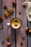 Christmas setting for foodphotography. Vinyl wooden background with cinnamon, coffee, chestnuts and  star anise