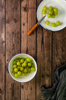 On vinyl printed wooden print for food photography and social media. Decorated with green grapes